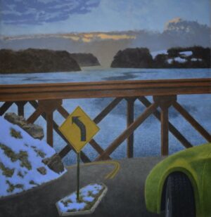 A yellow turn-left road sign stands on a snowy bridge overlooking a body of water at dusk.