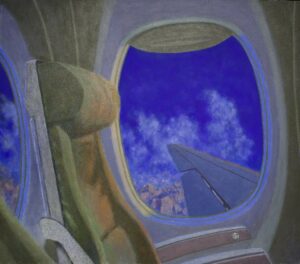 A view of clouds and an airplane wing from an airplane window next to a passenger seat.